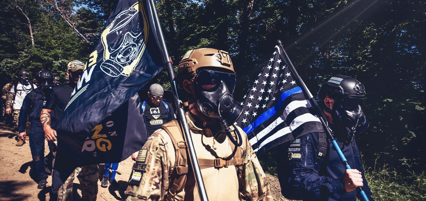 Operation Enduring Warrior veterans walking together holding their flag