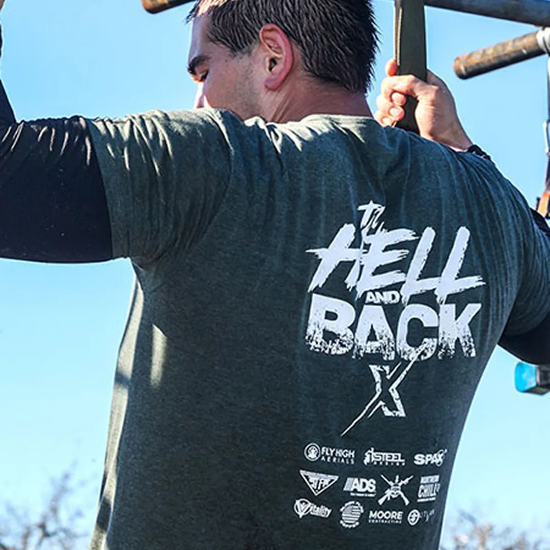 Man doing on obstacle in on obstacle course race wearing a dark gray shirt with the text 'To Hell and Back' on the back.